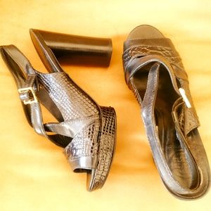 Tory Burch black embossed platform sandal.